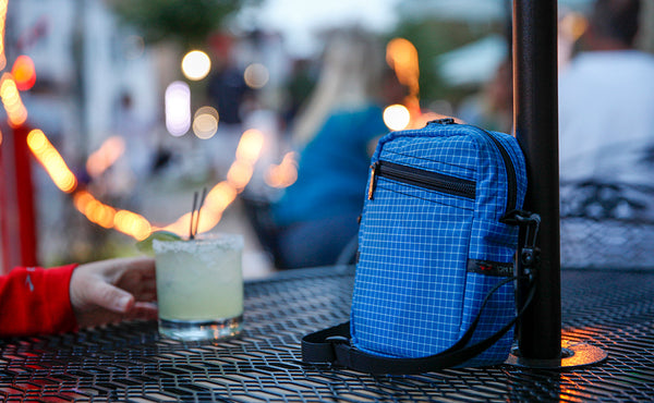 Everyday Cubelet next to a margarita at an outdoor restaurant or bar.